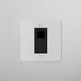 Paintable black CAT6 socket from the 1G Sockets & Modules range, installed on a white wall.