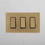 3G Two Way Rocker Switch in Antique Brass Black on a white wall, combining classic elegance with modern functionality.