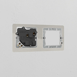 Polished Nickel 1G 50mm Module & Single Socket UK Plate on white wall, part of Brass Module Plates - White series.