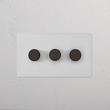 3G Dimmer Switch in paintable bronze finish with three round black buttons on a rectangular panel.