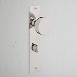 Onslow Long Plate Sprung Door Knob & Thumbturn in Polished Nickel on a light wall with a rectangular backplate.