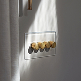 Clear Antique Brass 4G Two Way Dimmer Switch with four brass knobs on a transparent wall panel.