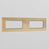 Antique Brass 4G 100mm Module Plate with four openings, showcasing a classic finish against a white wall.
