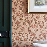 Clear antique brass 4G two-way toggle switch, part of 4G switches & dimmers line, mounted on vintage wallpaper.