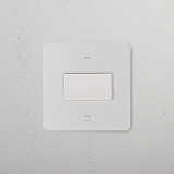 Paintable white fan isolator switch on a textured white wall, designed to blend seamlessly with any decor.