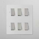 6G Two Way Rocker Switch - Paintable Polished Nickel White on a sleek panel for stylish wall integration.