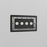 4G bronze switch plate made of brass with four cut-out holes for switches.