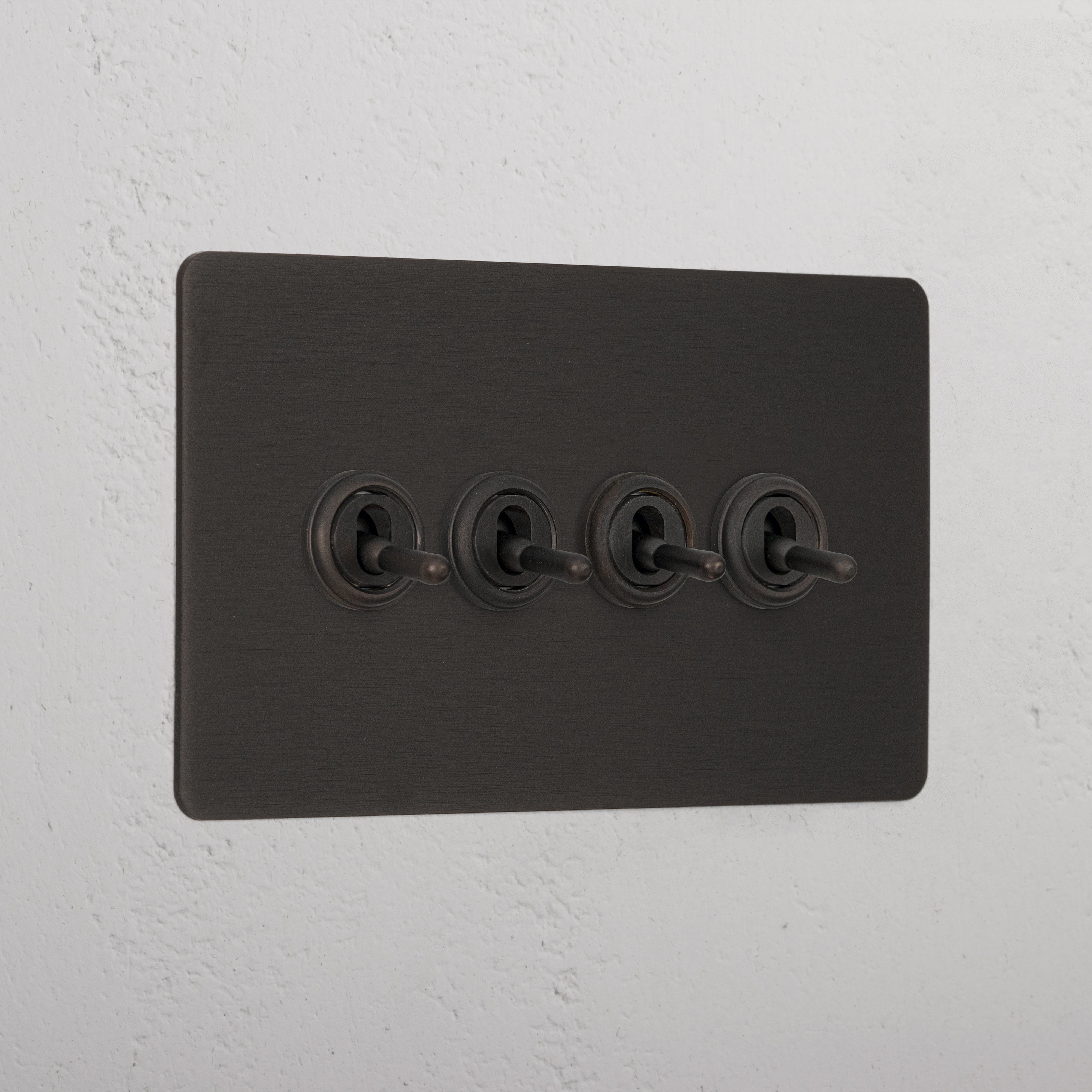 Bronze wall plate with four retractive toggle switches, '4G Toggle Retractive - Bronze'.