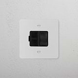 Paintable black isolator switch panel featuring a switched fused spur (FCU) on a white wall.