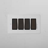 4G Two Way Rocker Switch - Paintable Bronze Black on a white textured wall.