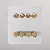 Paintable antique brass 8G switch with 4 toggles and 4 rotary dimmers on a white panel.