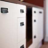 Bronze Elm Cup Handle 84mm on white kitchen cabinets, highlighting its elegant cup handle design.