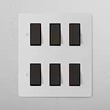 6G Two Way Rocker Switch - Paintable Bronze Black on a white panel; for 6G Switches & Dimmers.