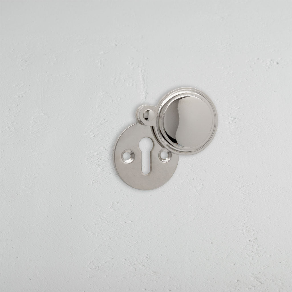 Polished Nickel Canning Covered Key Escutcheon On White Background