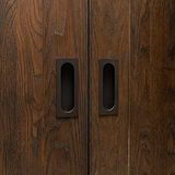 Dark wooden sliding closet doors with sleek bronze Regent Recessed Medium Pull handles.