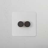 2G Dimmer Switch in paintable bronze finish with two round black knobs for adjusting light levels.