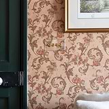 Clear antique brass 4G two-way toggle switch, part of 4G switches & dimmers line, mounted on vintage wallpaper.