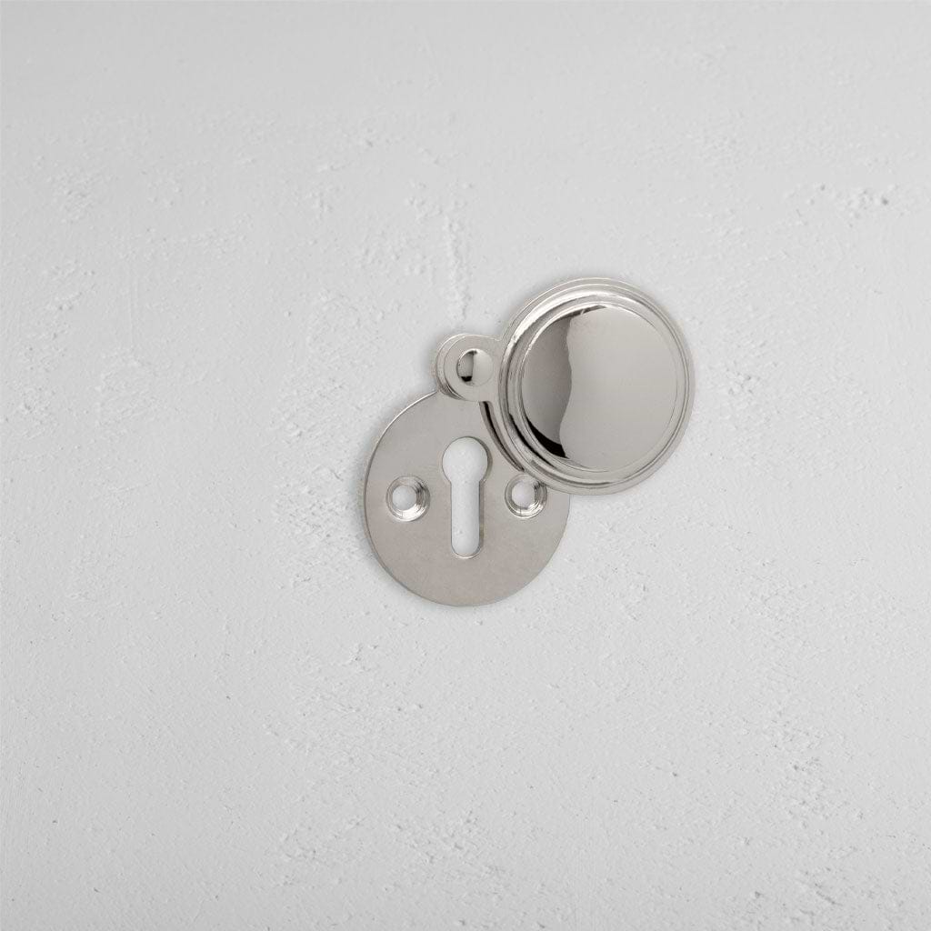 Polished Nickel Canning Covered Key Escutcheon on White Background