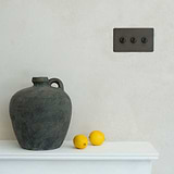3g bronze toggle switch above fire place with vase