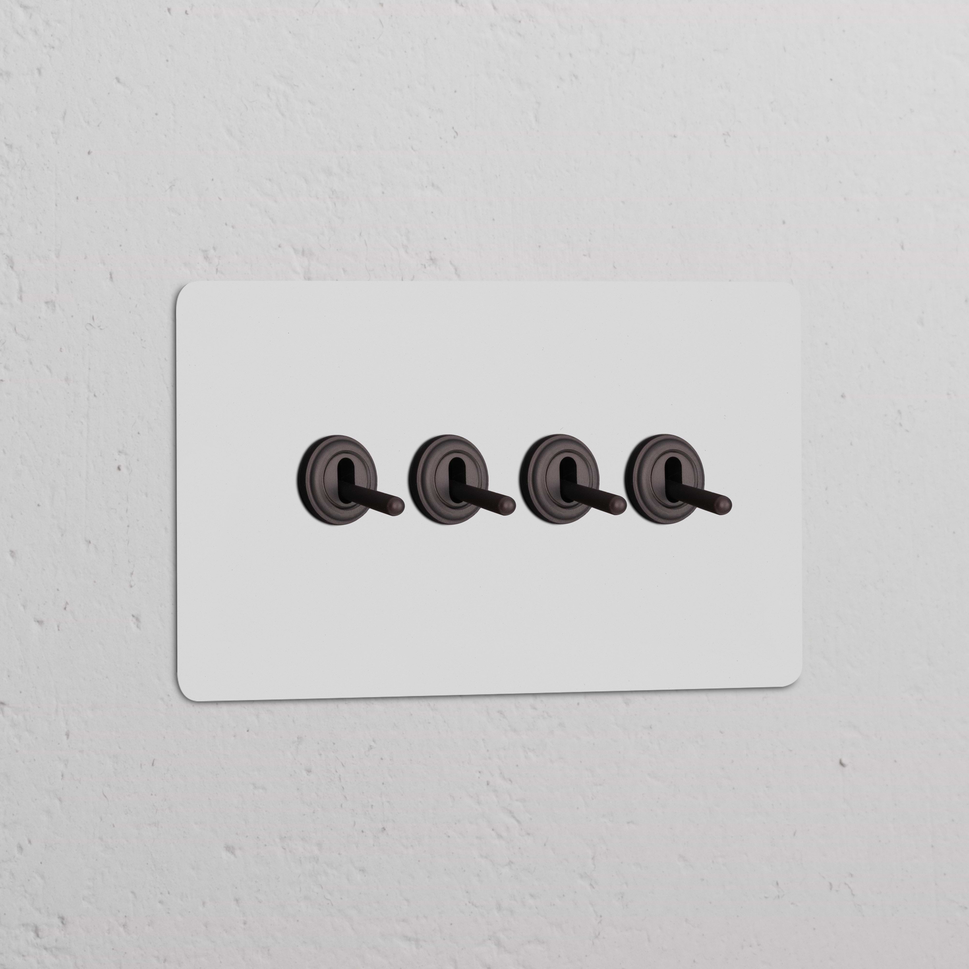 Interruptor conmutador de palanca x4 en marco doble pintable, acabado bronce.