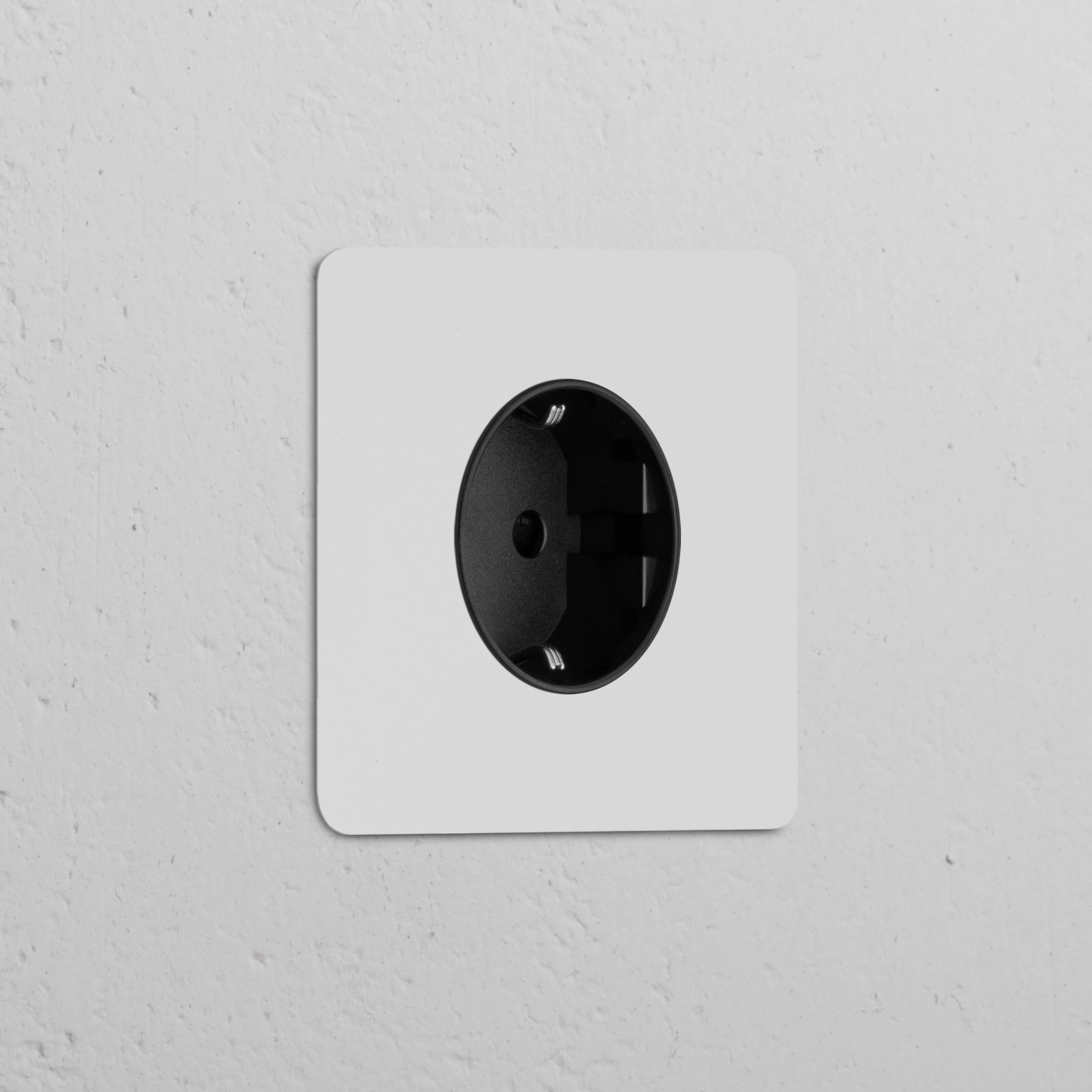 Módulo Schuko tipo F redondo (marco simple), pintable con inserto negro, para tomas eléctricas.