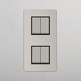 Interruptor para control de la luz de alta capacidad en diseño vertical sobre fondo blanco: Interruptor doble de balancín x4 en níquel pulido y negro con diseño vertical