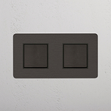 Interruptor de balancín de posición doble en bronce y negro, detalle contemporáneo casas modernas, sobre fondo blanco