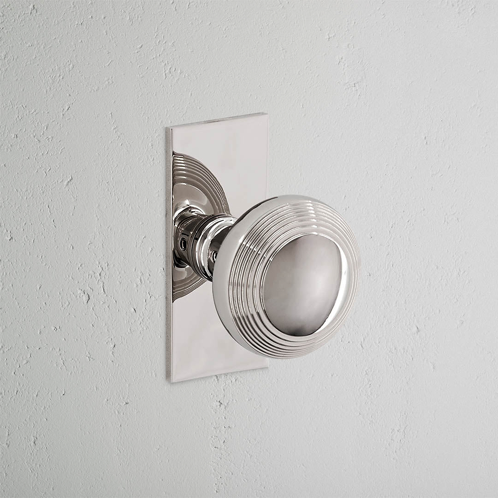 Pomo para puertas Poplar con placa corta (fijo) - Níquel pulido