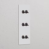 Interruptor conmutador de palanca x6 vertical (marco triple) - Pintable y bronce