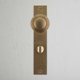 Pomo para puertas Poplar con placa larga (con muelle) y sistema giratorio - Latón antiguo