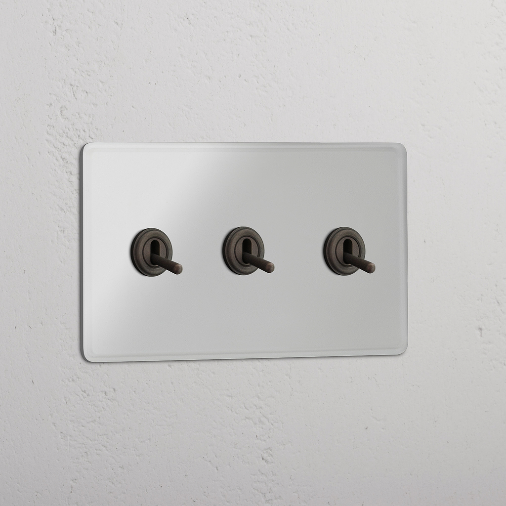 Interruptor triple de palanca en bronce y traslúcido - Accesorio para control de luces