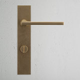 Manilla para puertas Clayton con placa larga (con muelle) y sistema giratorio - Latón antiguo