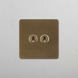 Dual Levers Toggle Switch, Single in Antique Brass on White Background