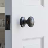 Bronze Poplar Fixed Door Knob on White Wooden Door