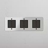Modern Six-Position Triple Rocker Switch in Clear Bronze Black for Light Control on White Background