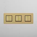 Triple Rocker Switch with Six Positions in Antique Brass Black on White Background