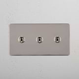 Versatile Triple Control Light Switch: Triple Toggle Switch in Polished Nickel on White Background