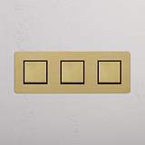 Antique Brass Black Triple Rocker Switch with Three Switching Positions on White Background
