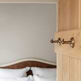 Two Antique Brass Hyde Hooks on A Door