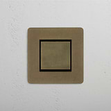 Central Position Rocker Switch in Antique Brass Black, Single Unit on White Background