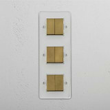 Superior Light Management Solution: Vertical Six-Position Triple Rocker Switch in Clear Antique Brass White on White Background