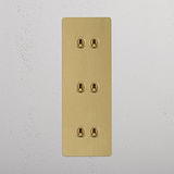 Six Lever Triple Vertical Toggle Switch in Antique Brass on White Background