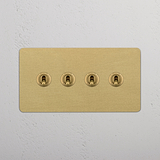 Four-Toggle Double Switch in Rich Antique Brass on White Background