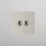 Dual Control Light Toggle Switch on White Background: Polished Nickel Single 2x Toggle Switch