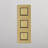 Three Position Vertical Rocker Switch in Antique Brass Black on White Background