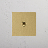 Retractive Toggle Switch, Single in Antique Brass on White Background