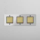 Triple Rocker Switch in Clear Antique Brass Black - Stylish Light Control Solution on White Background
