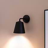 Bronze Richmond Medium Wall Light turned ON on Pink Background