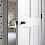 Bronze Poplar Sprung Knob on White Wooden Door