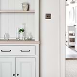 Bronze Sycamore Furniture Handle on Cream Furniture Next to Light Switch